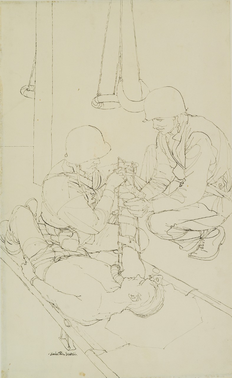 Two corpsmen work on a wounded man