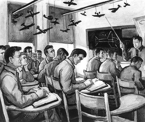 Cadets sit in a room while an instructor points at aircraft models attached to the ceiling