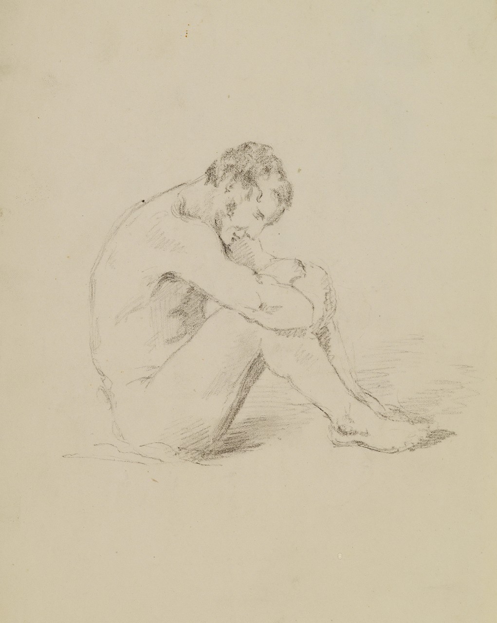 A man seated with his hands on his knees