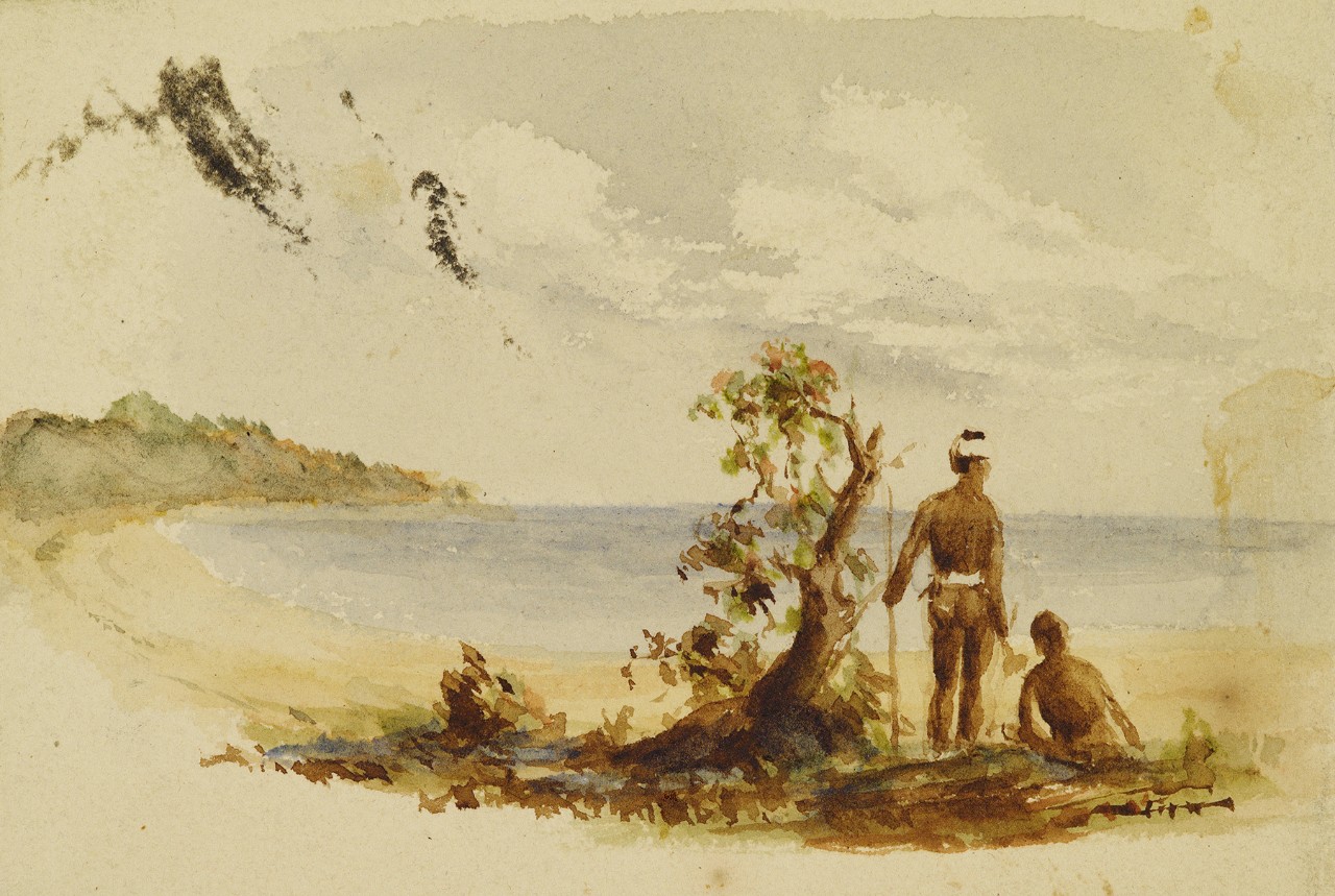 Two men standing by a bush looking at the ocean