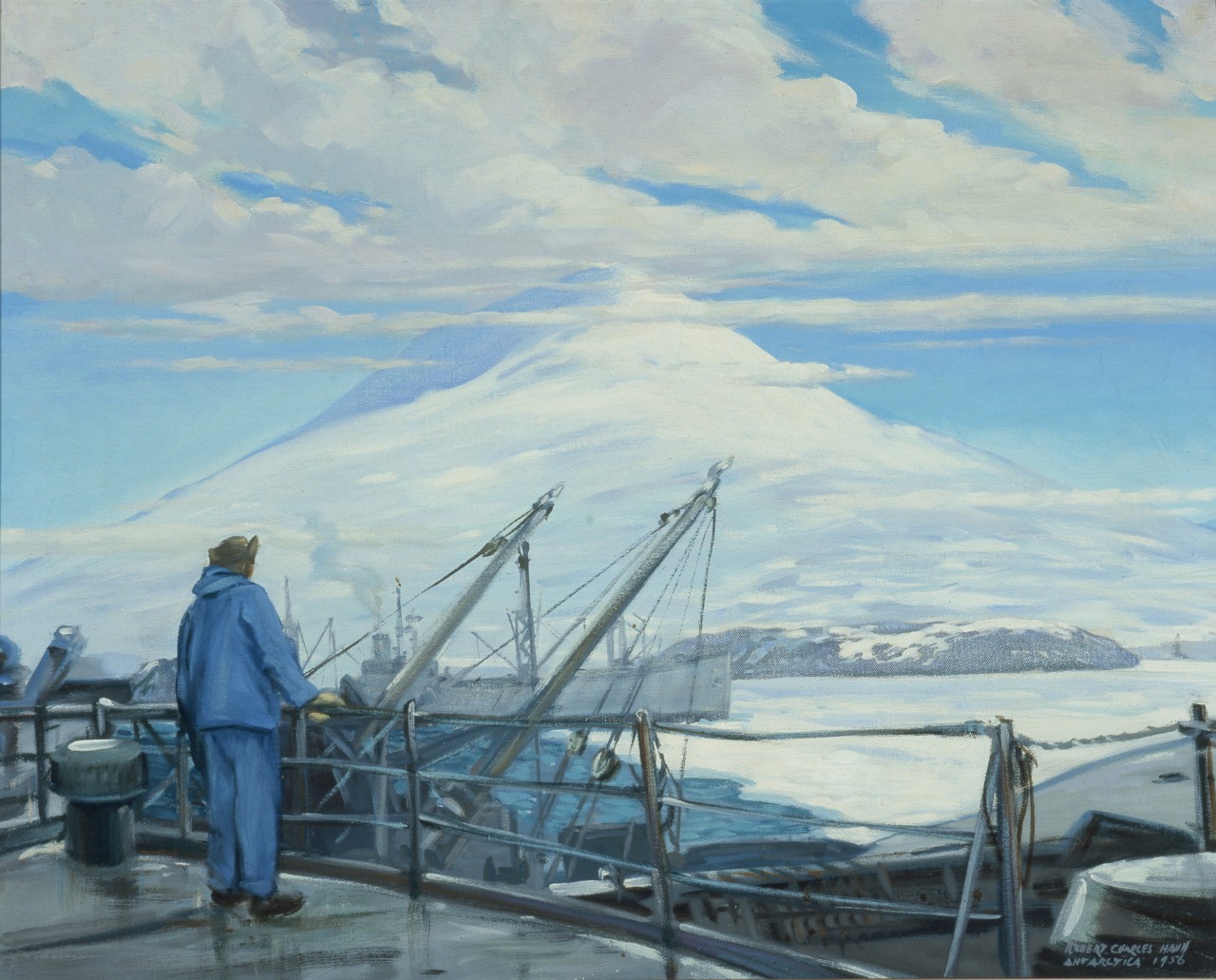Man on the deck of a ship is looking at a mountain