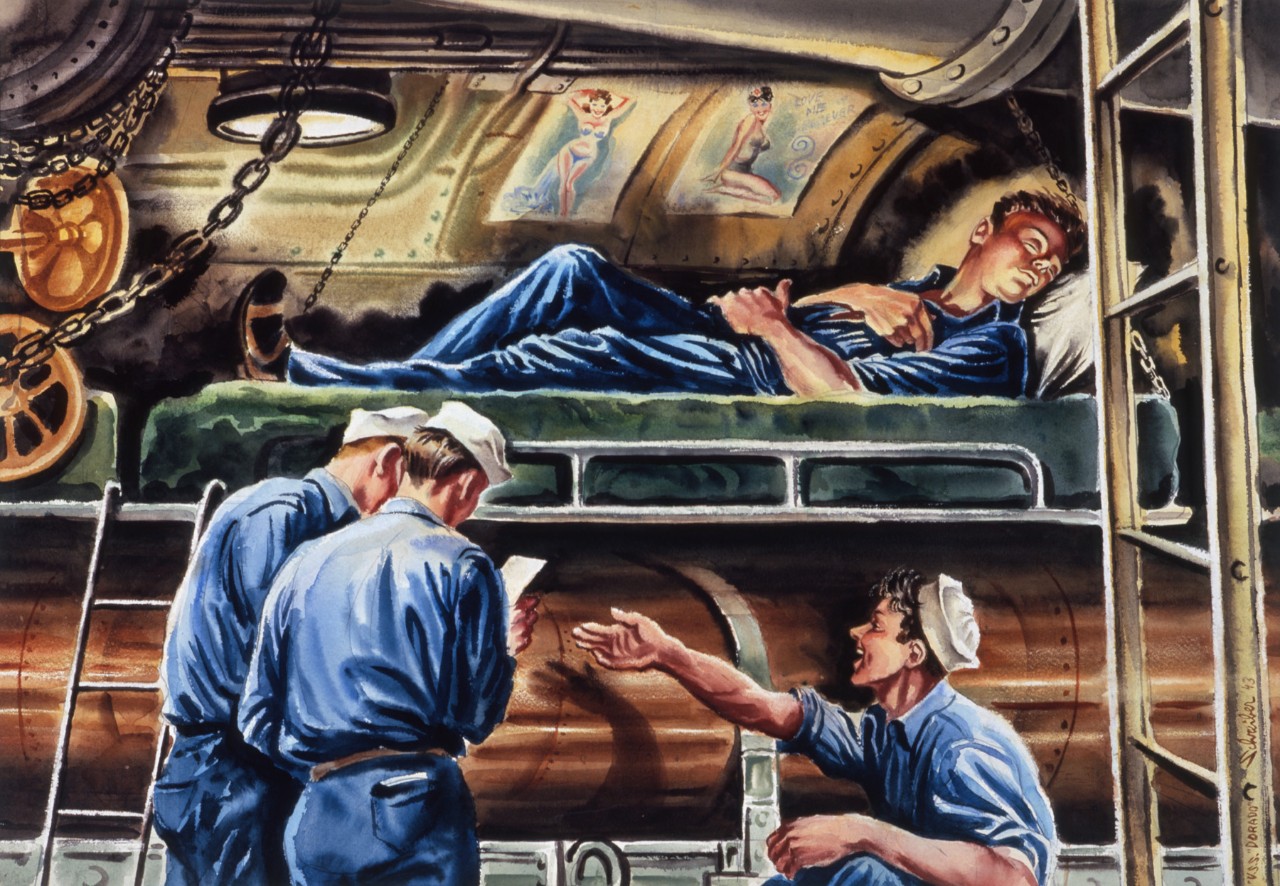 A sailor sleeps on his bunk above a torpedo while his shipmates read a lettler