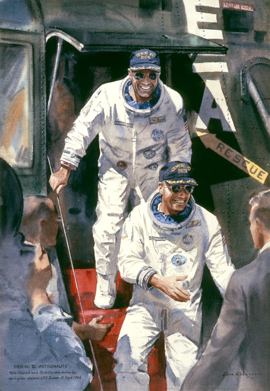 Two astronauts leave a helicopter and greet men on board ship