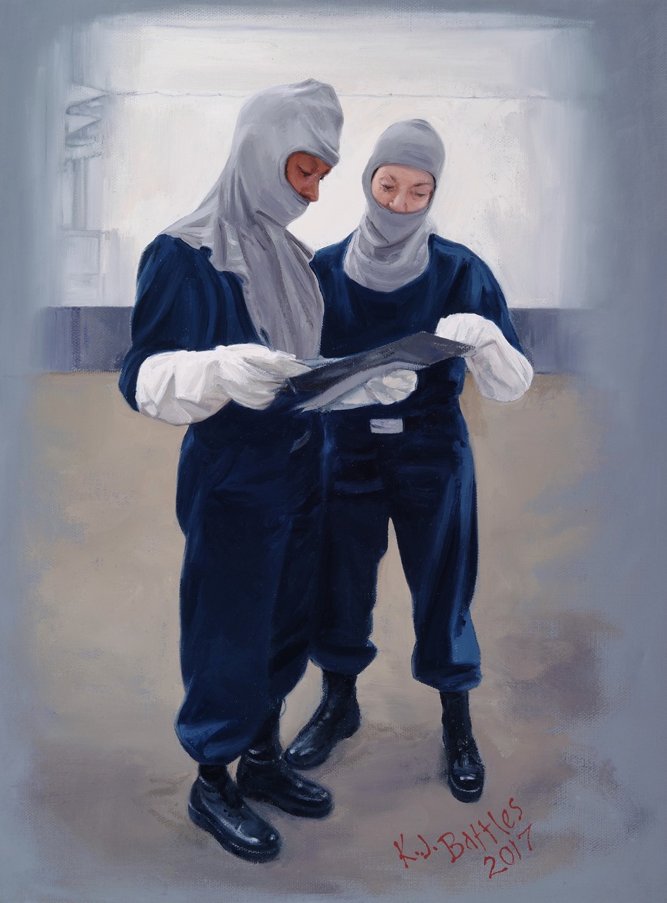 Two women in fire protection clothing are reviewing a check list on a clip board