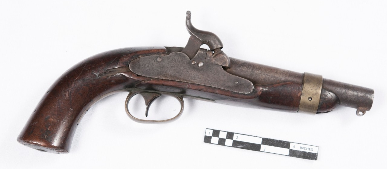 Obverse view of M1842 Ames percussion pistol. Wood stock with iron lockplate, hammer, and barrel. 