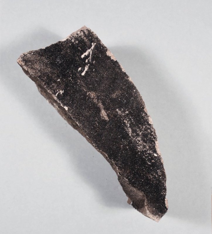 Piece of broken stone from Pentagon wall. Obverse side blackened from fire and smoke exposure.