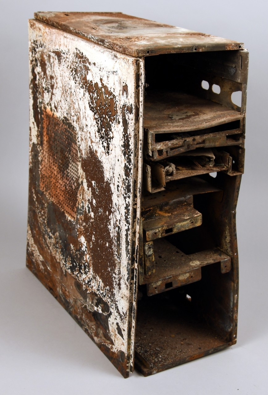 Proper rightview of desktop computer tower recoved from Pentagon following terrorist attack on September 11, 2001. Metal case covered in rust, warped, interior components removed. 