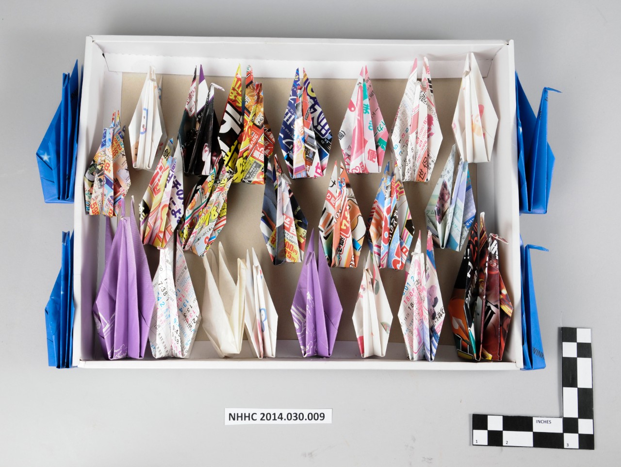 Folded paper cranes glued into box for display on the USNS Observation Island