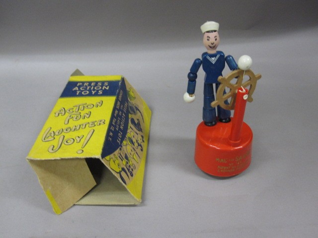 press toy color wood toy sailor at helm blue uniform red stand