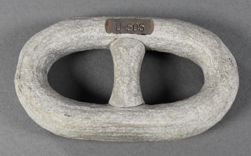 One anchor chain segment from the German submarine U-505. The link is painted white with an engraving marking its origins. 