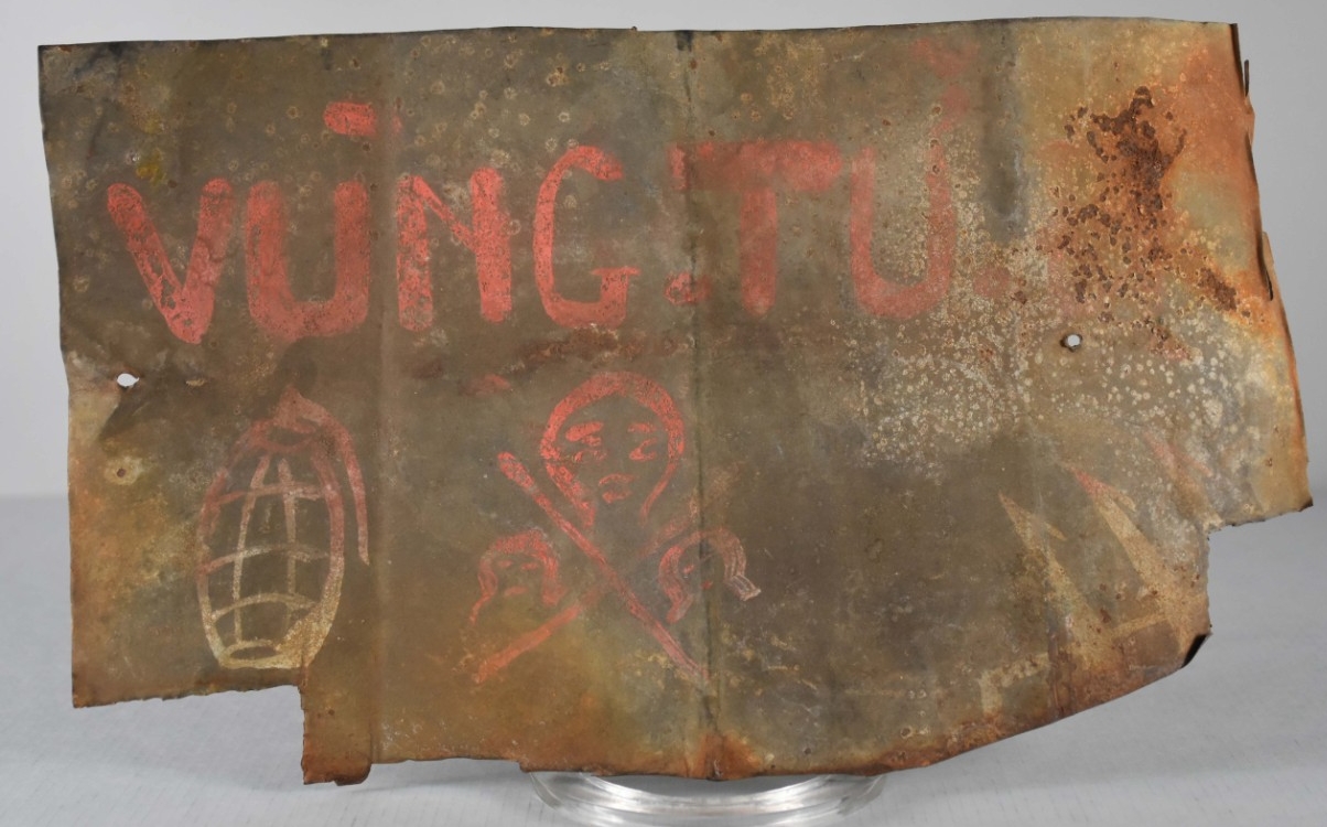 Rectangular scrap metal with pink hand painted lettering and images.