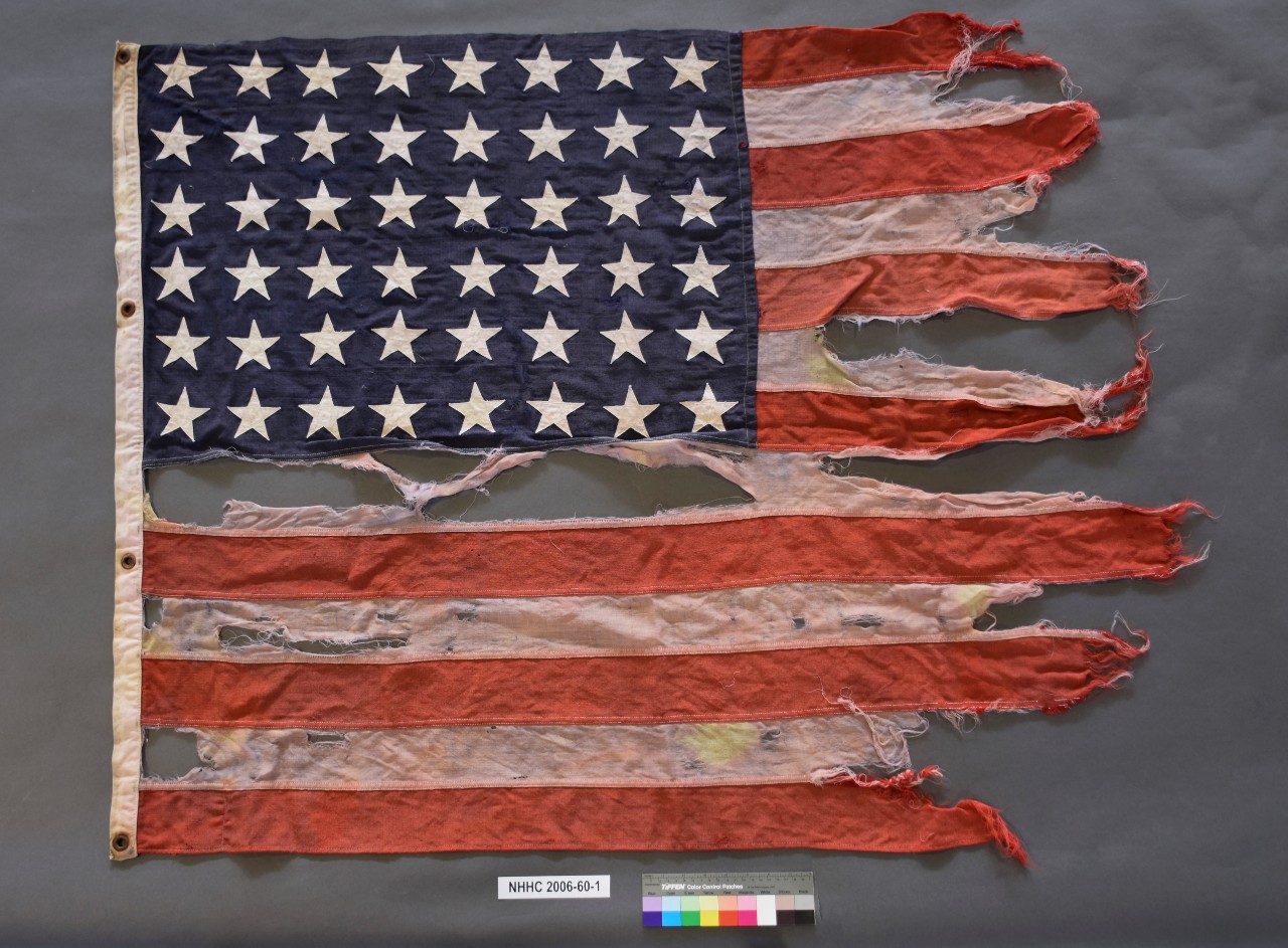 <p>One heavily frayed flag with 48 stars</p>
