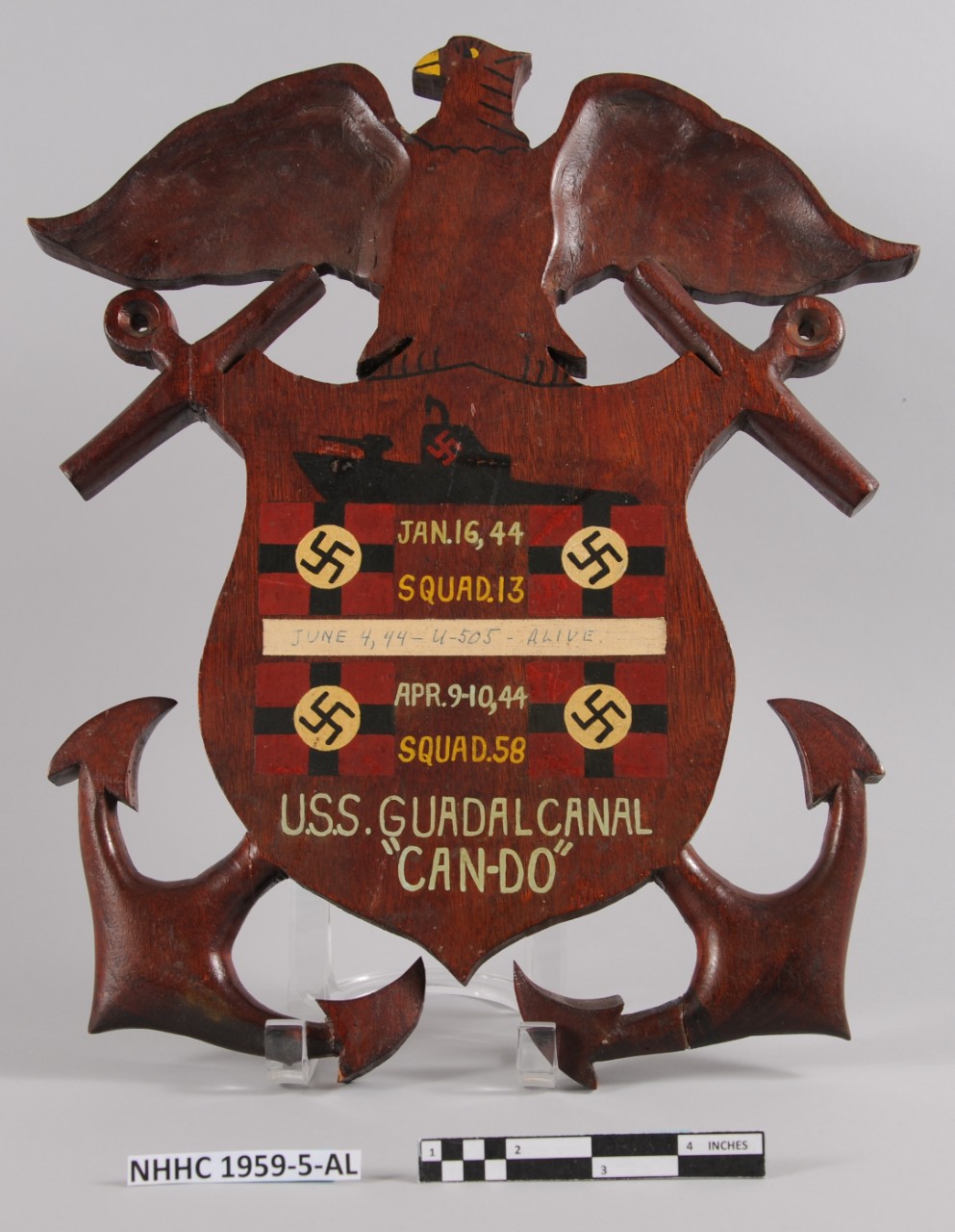 One US Navy Ship Submarine Victory Commemorative Plaque from the USS Guadalcanal (CVU-60/ CVE-60). Dark brown wood plaque consists of a shield in the center and an eagle with spread wings perched on top. Behind the shield are two crossed anchors....