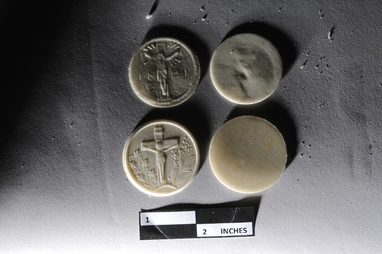 <p>Round wafers with raised image religious depictions of Jesus</p>
