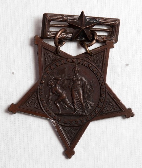 Obverse of Medal of Honor bronze five pointed star with center depiction of Minerva repulsing discord
