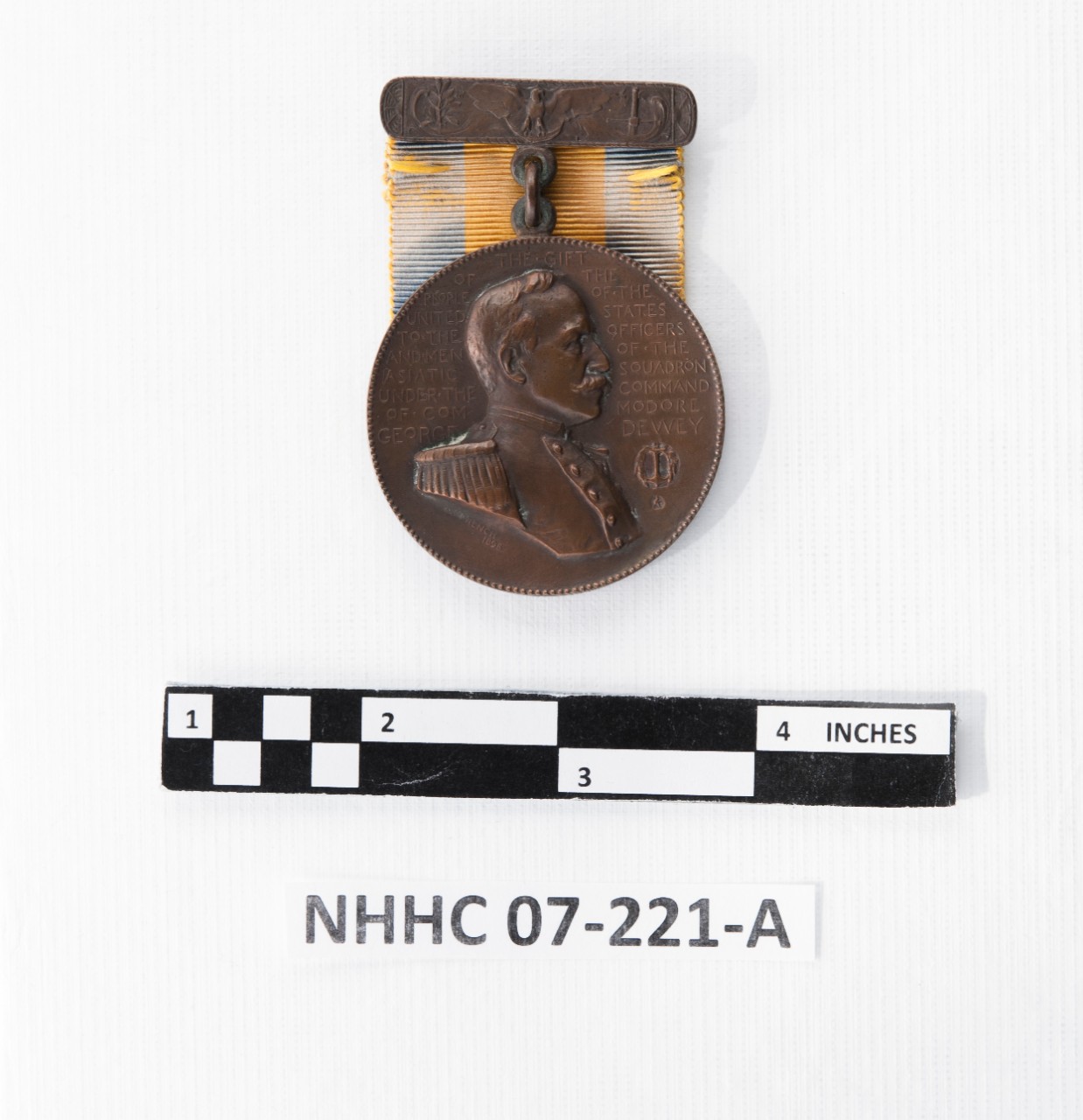 Medal with bust of dewey and text. eagle and sword depiction ribbon bar
