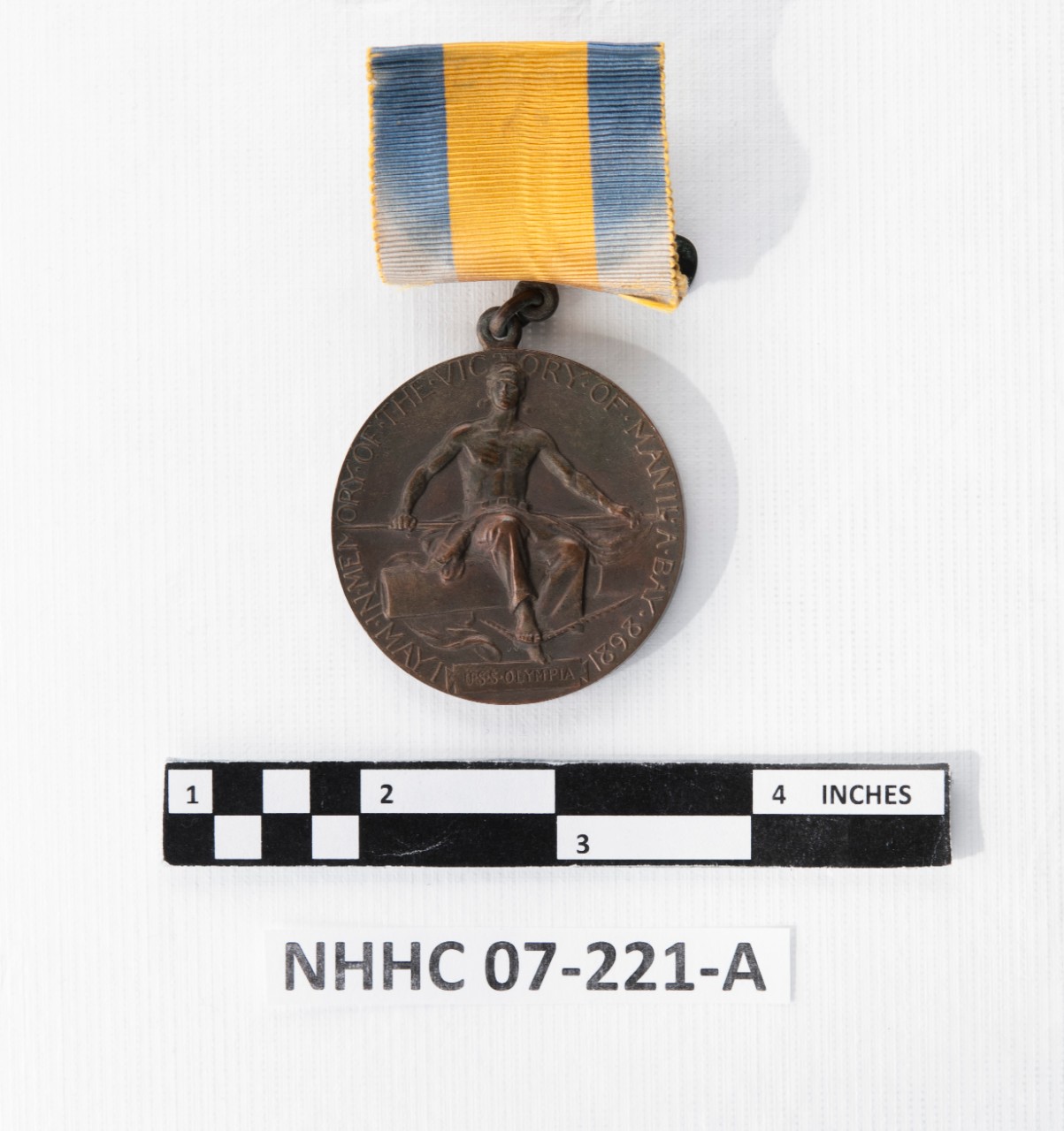 Reverse of Battle of Manila Bay Medal with Ribbon. Sailor on a gun
