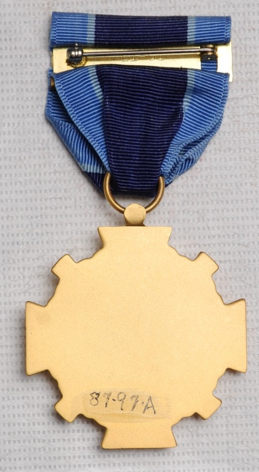 <p>Reverse of Distinguished Service Medal showing blank planchet and pin and clasp brooch.</p>
