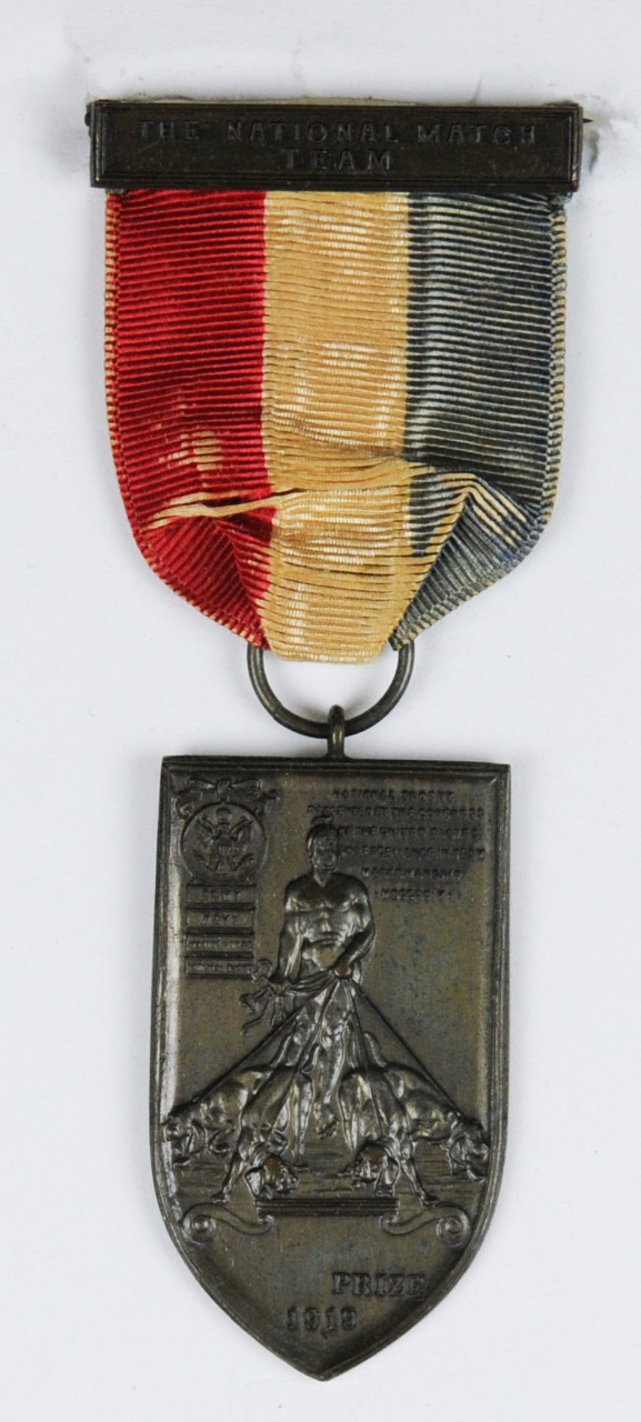 National Team Match Medal of Carl T Osburn from 1919 shield shaped planchette with red white and blue ribbon and pin and clasp bar