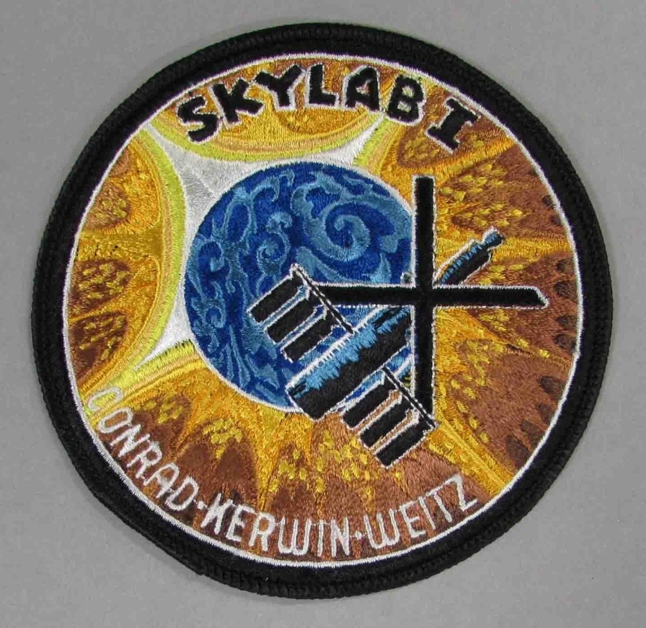 Multicolored circular fabric patch embroidered with Skylab motif and reads "SKYLAB I / CONRAD-KERWIN-WEITZ."   