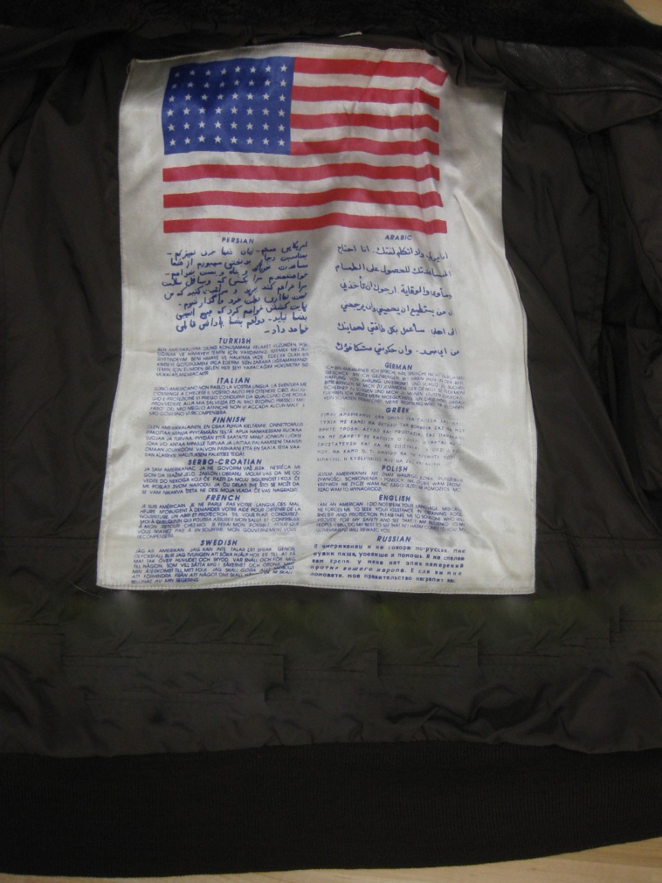 <p>detail image of blood chit with us flag and a statement of safety in multiple languages</p>
