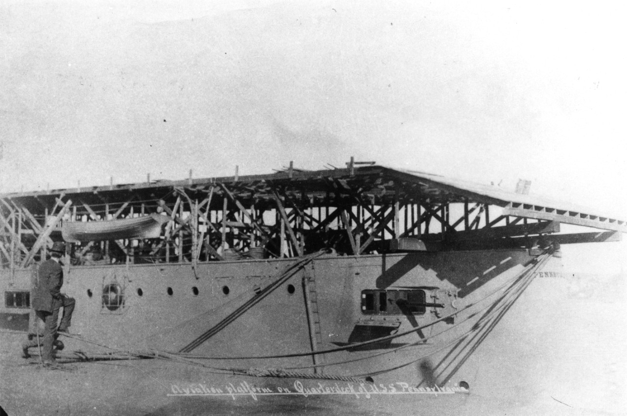 9 black and white photos donated by Lieutenant Louis W. Brugler, USN (Ret). 8 images of the landing and takeoff by Eugene Ely on the deck of USS Pennsylvania (ACR-4) in January 1911. Most of the Ely images are copies of images in the NH collection. 1 photo of US Navy Lockheed RV6 Constitution passenger plane.