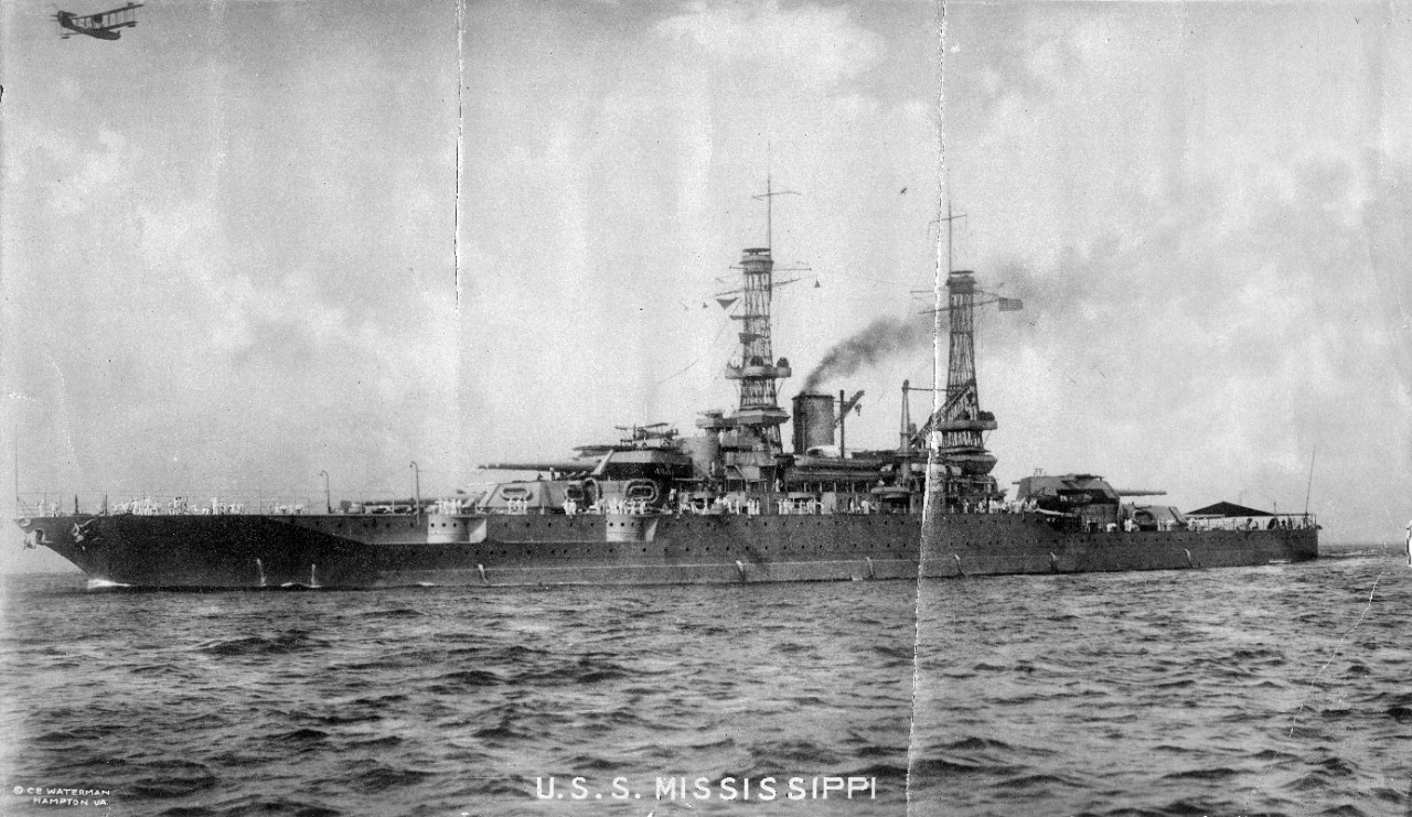 2 black and white photographs of USS Mississippi (BB-41). 1 large panorama of the battleship with her crew assembled for a formal portrait pierside, 12 July 1919, Norfolk Navy Yard. 1 oversize black and white image of the ship underway at sea. Both images are fragile, with tears and cracks. 