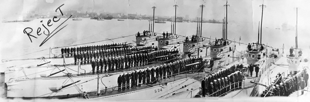 One 5-foot long panorama black and white panorama photo of U.S. Navy submarines S-24 (SS-129), S-25 (SS-130), S-26 (SS-131), S-27 (SS-132), S-28 (SS-133), and S-29 (SS-134), with crews assembled on deck. The word “Reject” is written in black marker on the surface of the print.
