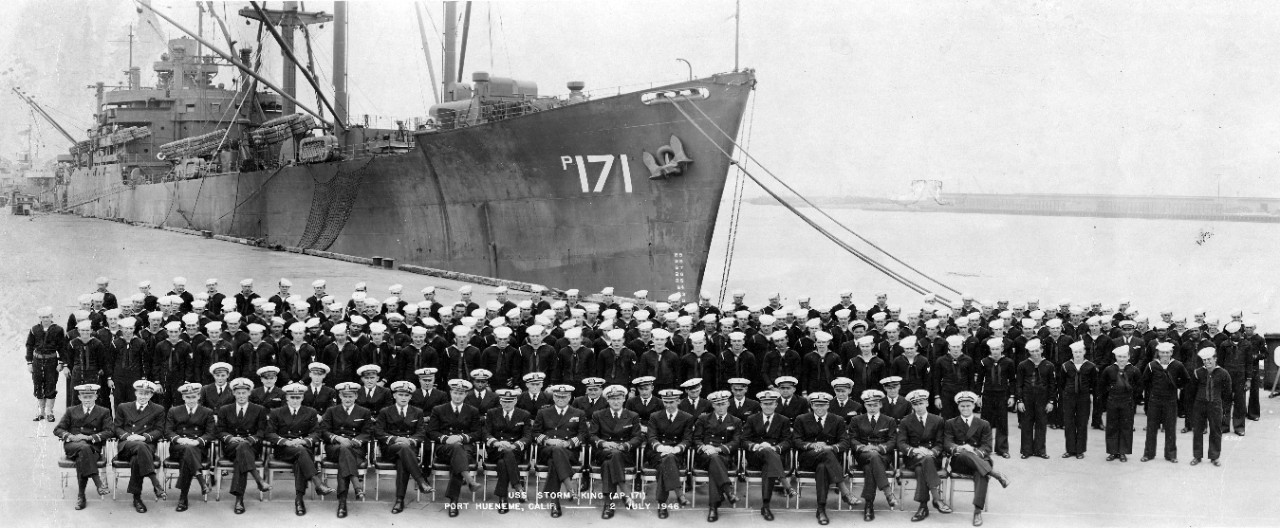 Photo of USS Storm King (AP-171) pier-side at Port Hueneme, CA, 2 July, 1946 with her officers and crew in formation. The commanding officer is Capt. Harry J. Hansen.  Photo NH 96685 is also from this collection. 