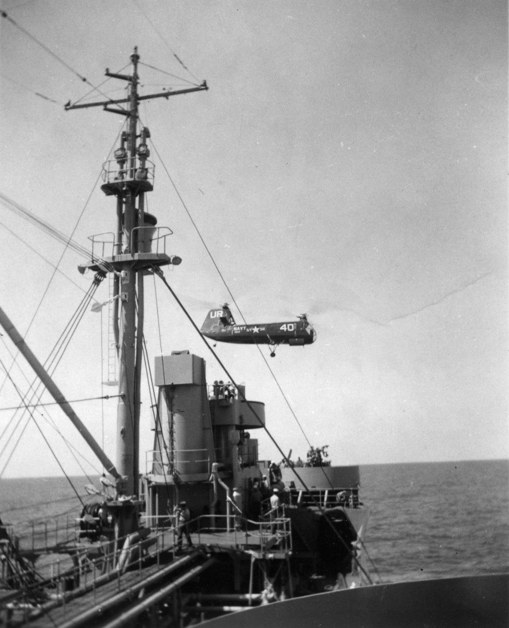 Collection of 36 black and white photographs and 1 postcards, formerly belonging to the donor’s father, James R. Jack, who served in the Navy in the 1950’s. Good views of underway replenishment, mostly taken from on board USS Marias (AO-57). Other ships shown include: USS Altair (AKS-32), USS Allagash (AO-97), USS Coral Sea (CVA-43), USS Plymouth Rock (LSD-29), USS Mississinewa (AO-144), and an unidentified destroyer. Also seen: coming into port at Naples; ship’s band playing; swim call; small boat operations; highline operations; mail operations involving Piasecki HUP-2 Retriever Helicopter.