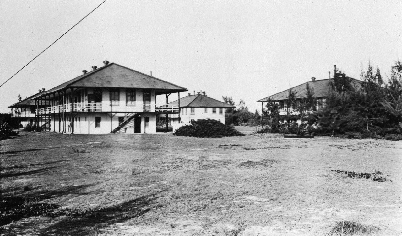 16 black and white photographs of Midway Island in the early 20th century, showing barracks, quarters, recreational facilities and windmills. Some photos have been assigned NH numbers.