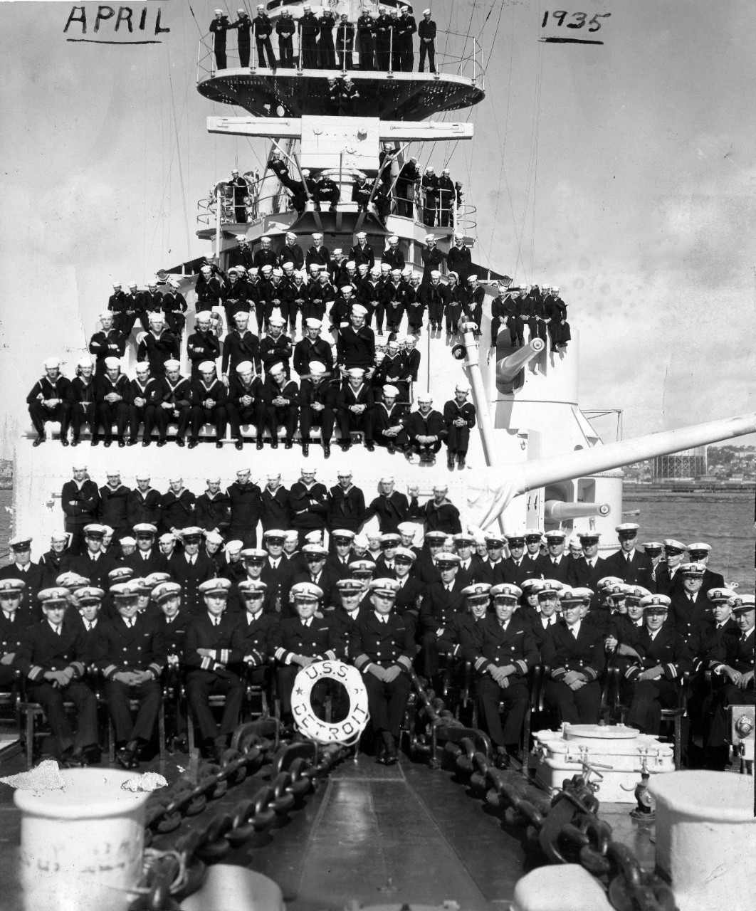 Collection of seven photographs related to USS Detroit (CL-8), circa 1935-1936. The relationship between the donor and the photographs is unknown . The subject matter of the image includes: onboard activities (barber shop, band, loading stores, and a Christmas party), ship’s officers and crew, and the ship’s basketball team. Also included are two photos of Japanese gunboats (unidentified). 