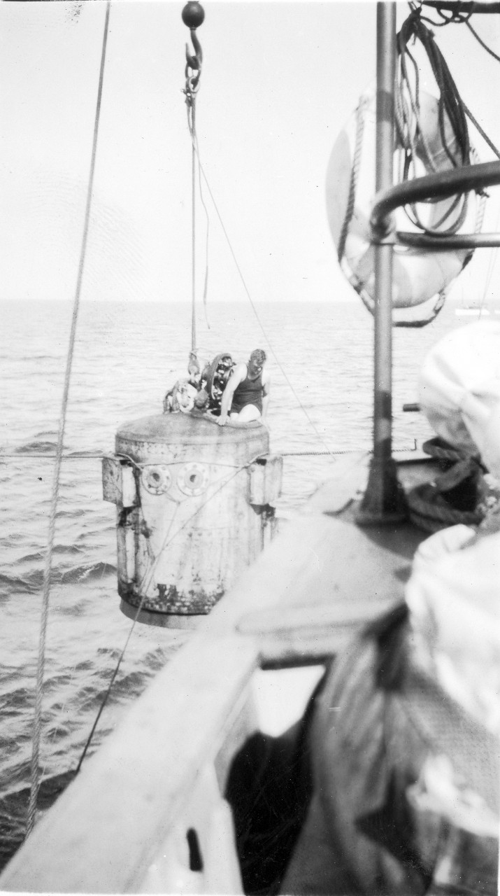 Coming out of the hatch after testing the O'Rourke diving bell. The bell is being hoisted from the submarine rescue ship, USS Falcon (ASR-2). 