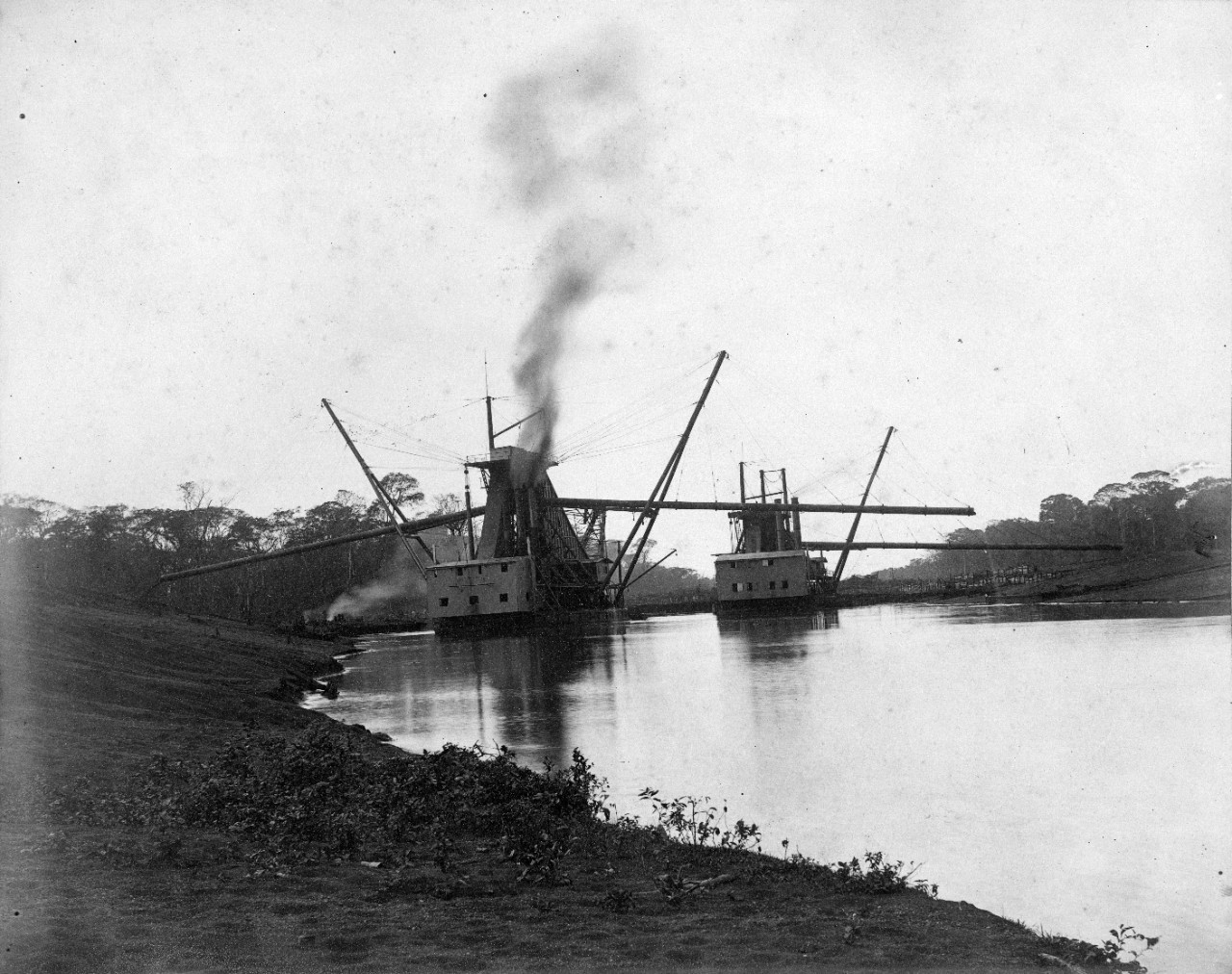 22 oversize photos, mounted on cardboard, showing construction of the failed Nicaragua Canal, circa 1890. Views of clearing of land, and extensive views of dredges and dredging operations. Views of Managua, and buildings near the operation.