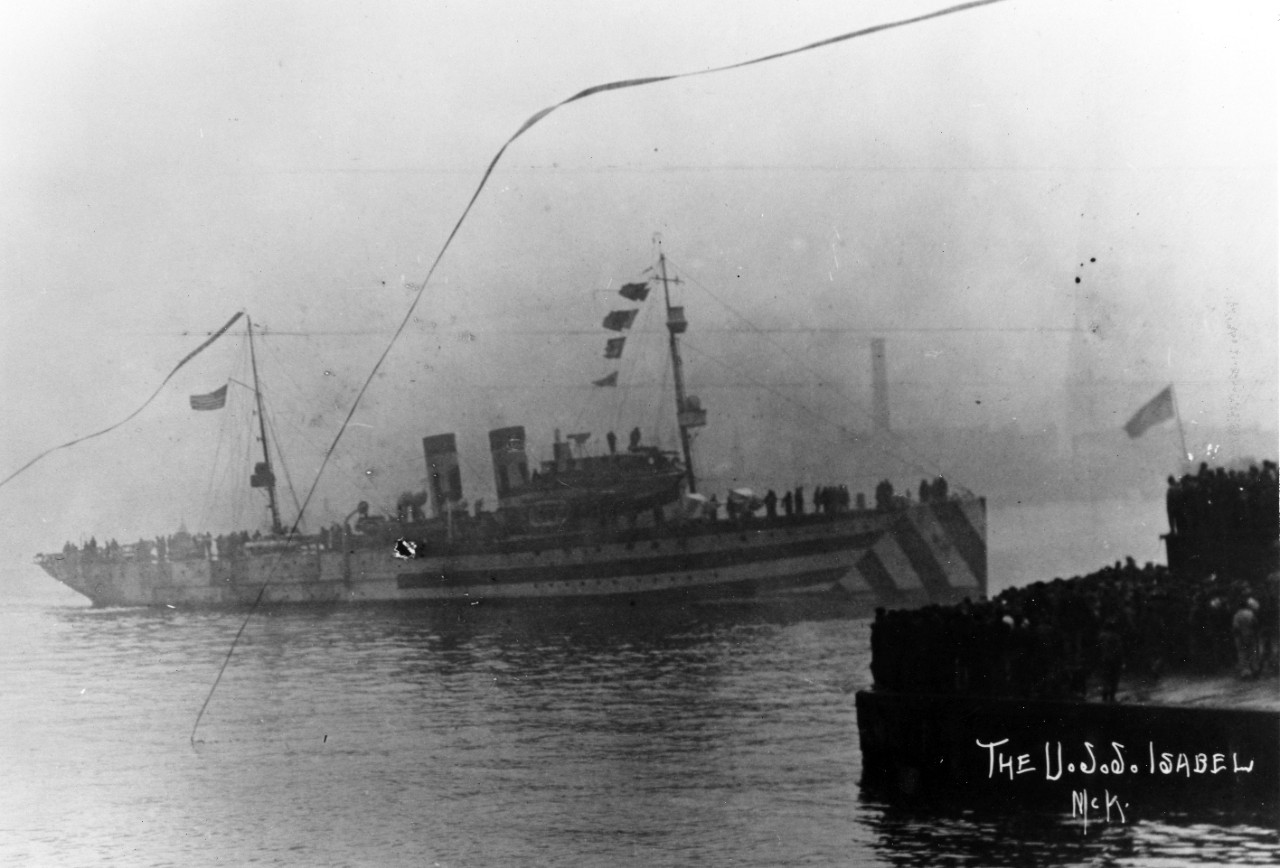Donation of five b/w photographs (copies) of WWI ships returning from service. Ships include: USS Drayton (destroyer #23), USS Isabel (SP-521) in camouflage, and USS Tucker (DD-57). Several images show crowds of cheering people on the dock as the ship pulls in. 