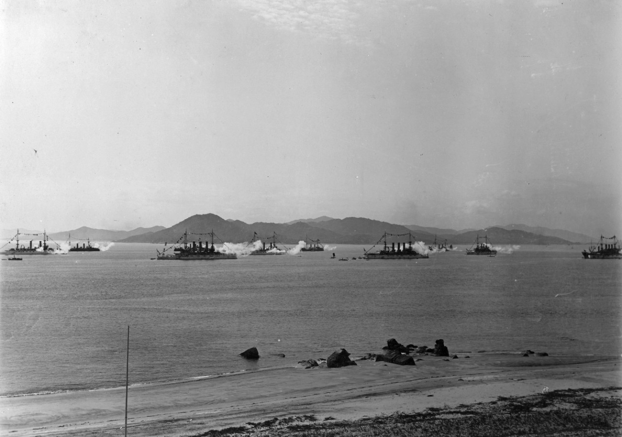 8 oversize prints showing the US Navy at Amoy, China, in 1908, during the worldwide cruise of the Great White Fleet. Most images show an elaborate parade ground, sports field, viewing stands, buildings, and ceremonial entrance constructed by the locals for the arrival of the squadron. One photos of US ships firing a salute, including USS Virginia (BB-13), USS Missouri (BB-63), USS Kearsarge (BB-5) and USS Kentucky (BB-6). All photos have been assigned NH numbers.