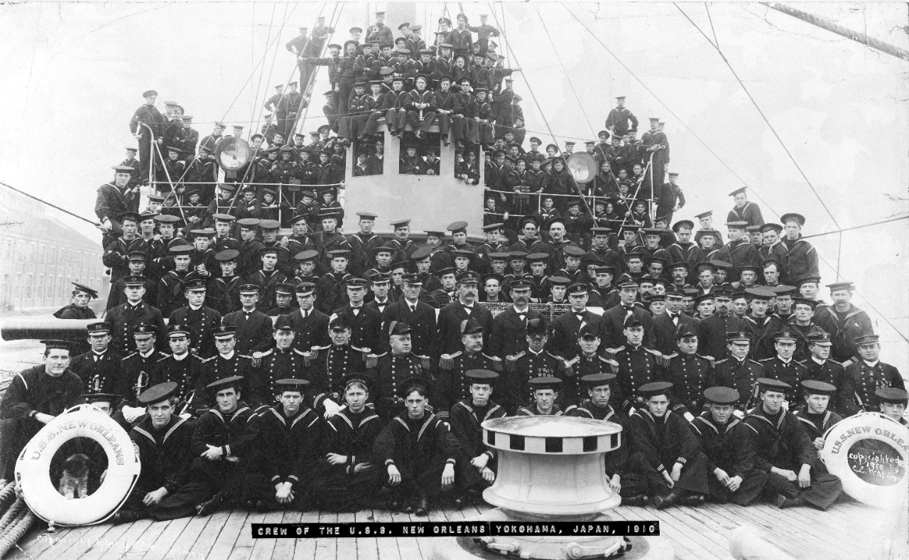 Collection of two oversized images of the crew of USS New Orleans at Yokohama (CL-22), Japan, 1910 (New Orleans returned to Asiatic duty at Yokohama on 25 April 1910. She cruised the Orient until returning to Bremerton, Washington, on 14 February 1912 and going into reserve). One of the photos is of the officers and crew taken aboard the ship and the other is of the crew in formation in port.