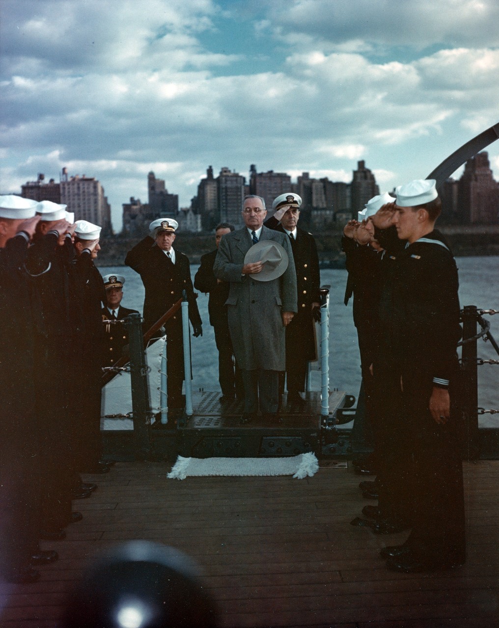 President Harry S. Truman is piped aboard USS Missouri (BB-63), during the Navy Day fleet review in the Hudson River, New York City, 27 October 1945. Fleet Admiral William D. Leahy is just behind the President.
