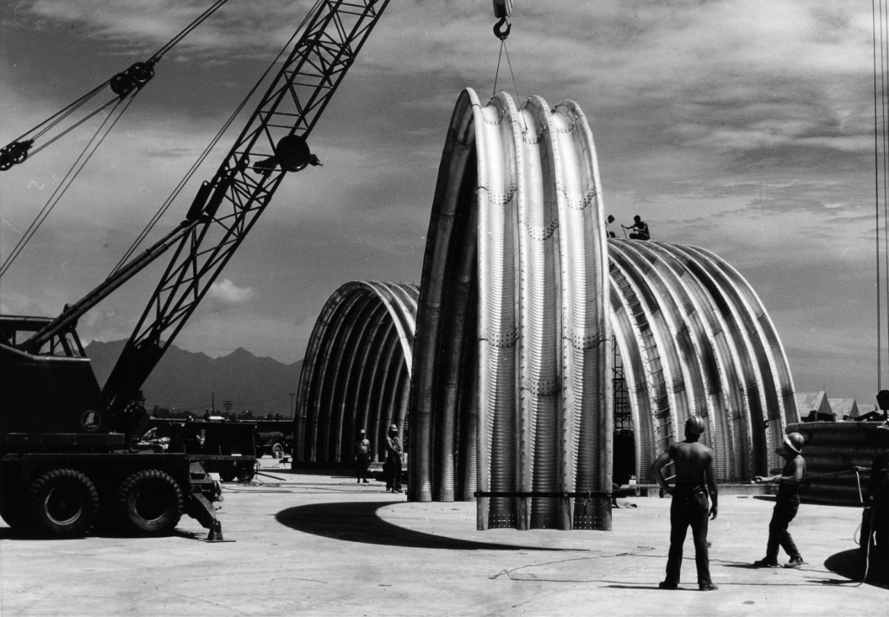 Seabees of U.S. Naval Mobile Construction Battalion Eight move a section of an aircraft shelter into place at the Marine Air Group Eleven Area, Da Nang, Republic of Vietnam.