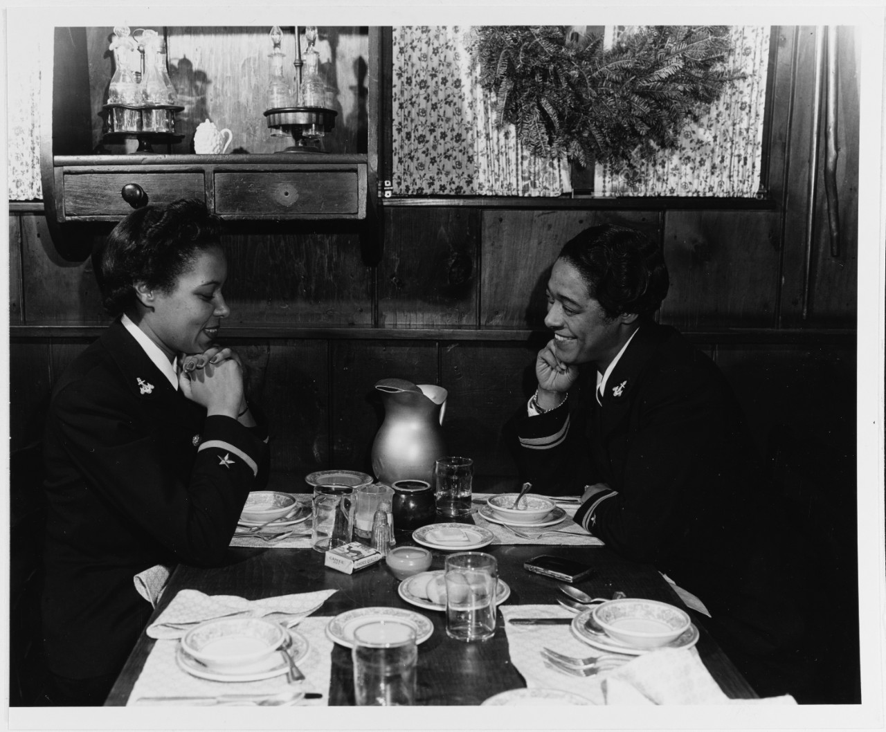 Photo #: 80-G-297437 Ensign Frances Wills (left) and Lieutenant (Junior Grade) Harriet Ida Pickens enjoy lunch following their graduation from the Naval Reserve Midshipmen's School (WR) at Northampton, Massachusetts, circa December 1944. They were members of the school's final class, and were the Navy's first African-American WAVES officers. Official U.S. Navy Photograph, now in the collections of the National Archives.