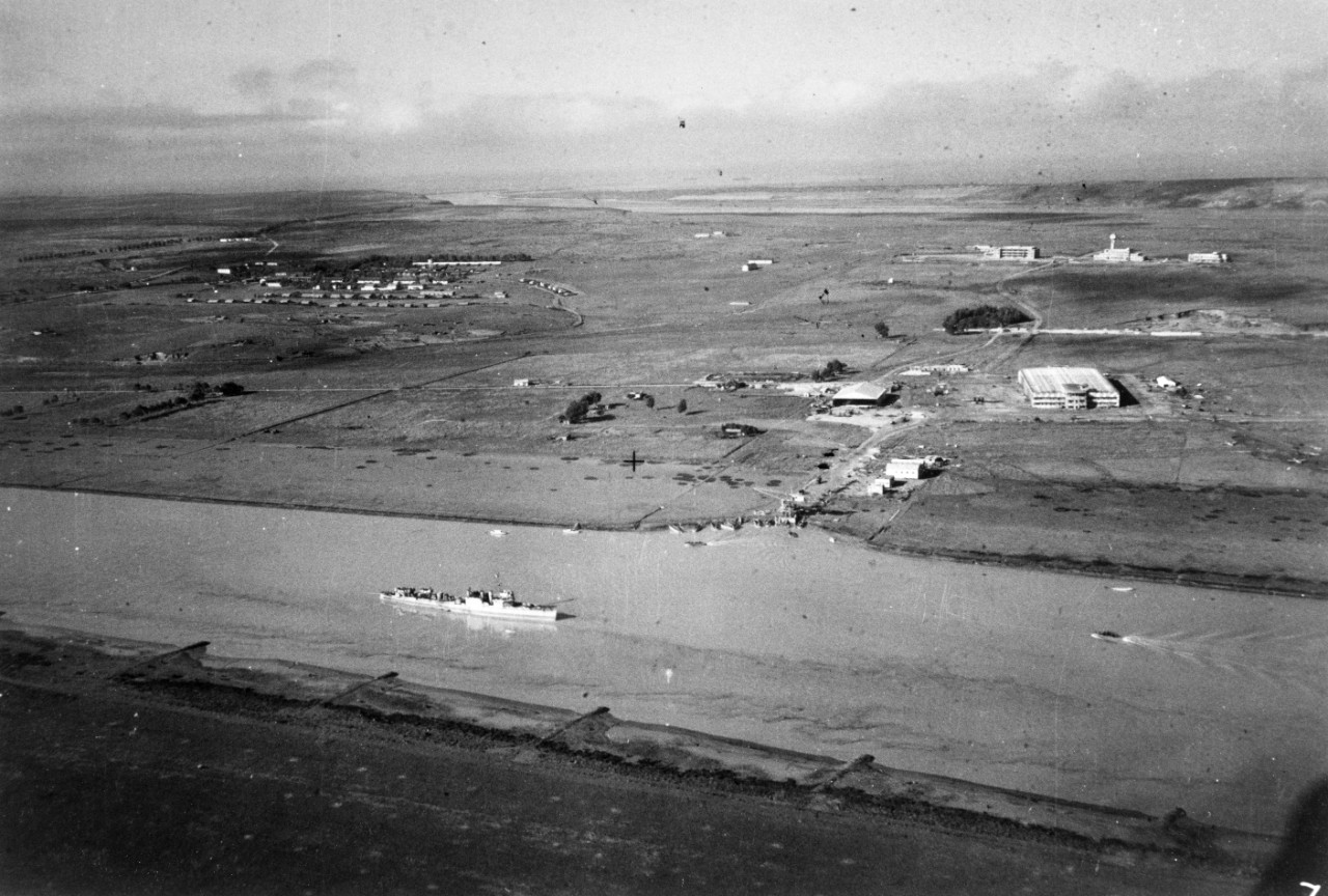 USS Dallas (DD-199) in the Wadi Sebou, off Port Lyautey Millitary Airfield, Morocco, 11 November 1942, the day after she made her way up the river to land U.S. troops at the airfield. Note U.S. Navy landing craft beached at the facility's waterfront and French military planes between the hangars. Seaplane hangars and shops are in the foreground, and aircraft assembly plant is in the background.