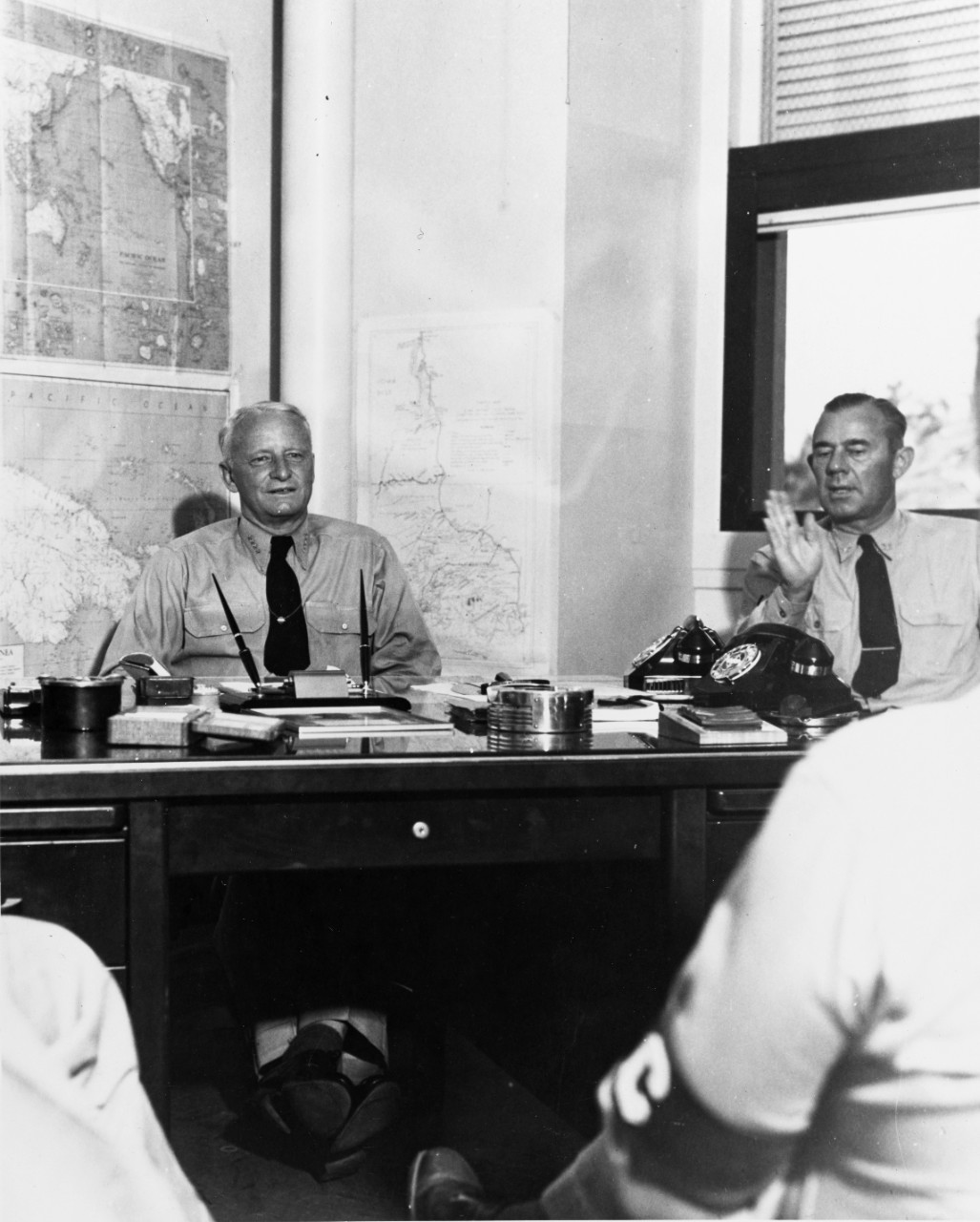 Gives his fifth press conference of the war at Pacific Fleet Headquarters, Pearl Harbor, 24 November 1942. He reviewed the first year of the Pacific War. As right, is his Assistant chief of Staff, CAPT. L.J. Wiltse. 