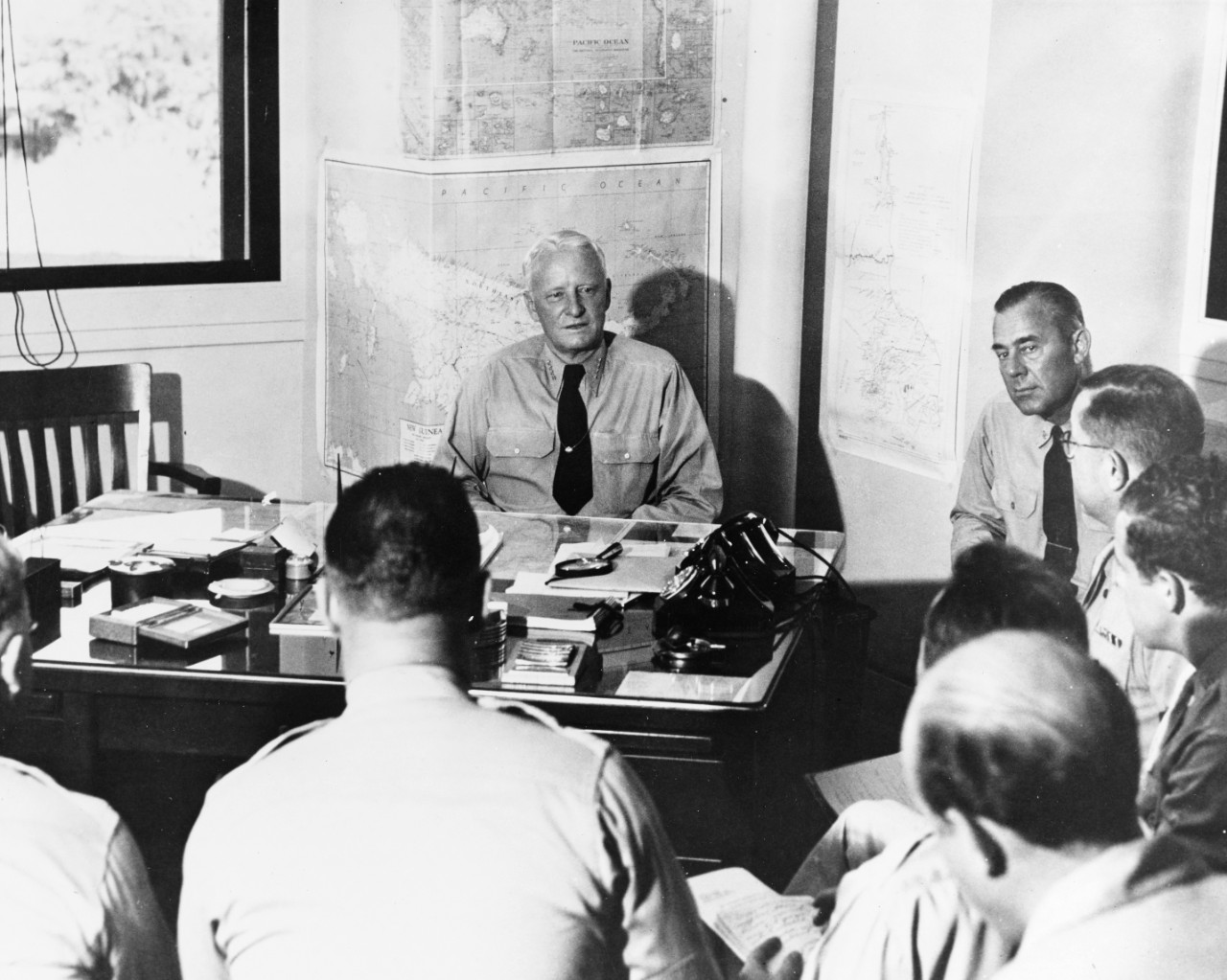 Gives his fifth press conference of the war at Pacific Fleet Headquarters, Pearl Harbor, 24 November, 1942. At right, is Assistant Chief of Staff CAPT L.J. Wiltse.