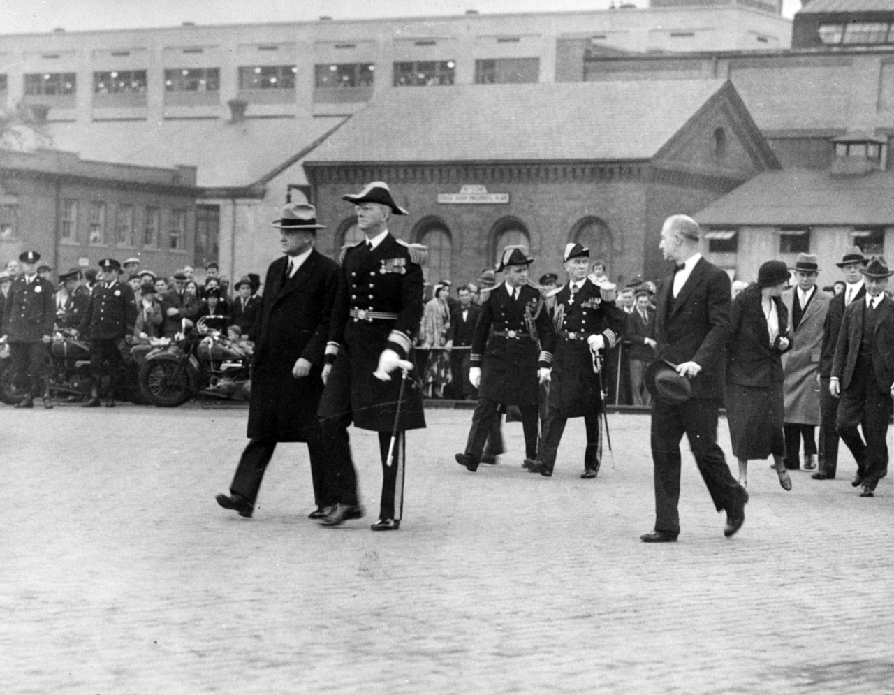 President Herbert Hoover on his way to the presidential barge to inspect USS Constitution at the Washington Navy Yard.