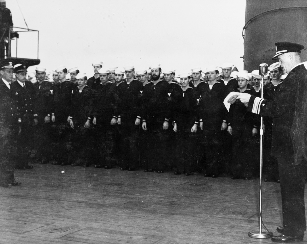 Rear Admiral Robert Griffin reading the citation awarded to the officers and crew of USS San Francisco (CA-38), on board the ship on 18 July 1943.