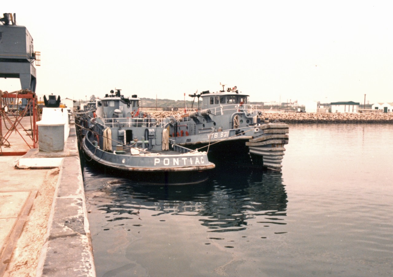 Large Harbor Tugs Pontiac (YTB-756), at left, and Dekanawida (YTB-831) tied up at a pier at Naval Station Rota, Spain
