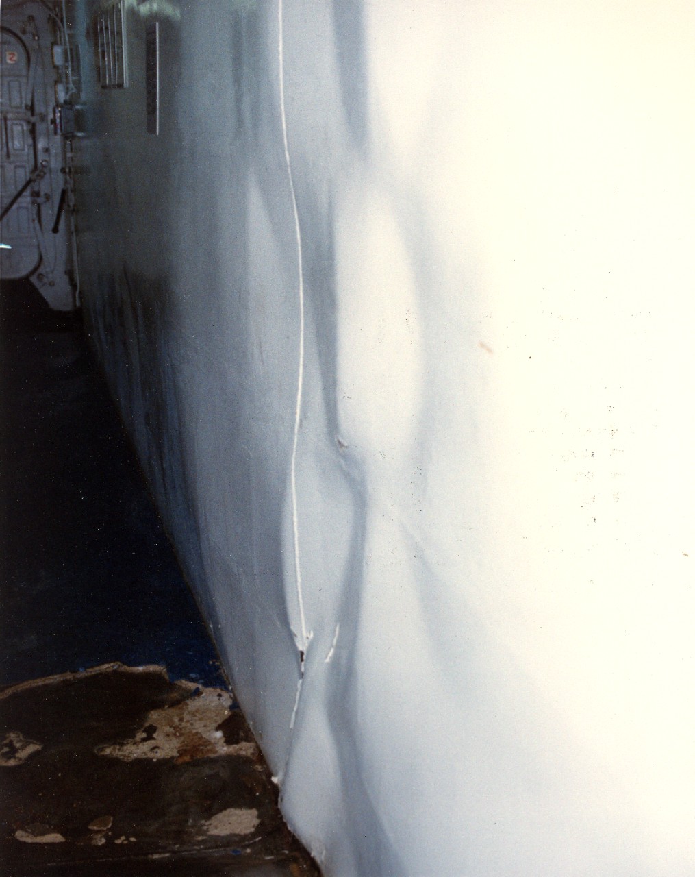 A close-up view of buckling in a bulkhead aboard the USS Samuel B. Roberts (FFG-58) after the ship struck a mine in the Persian Gulf on April 14, 1988.