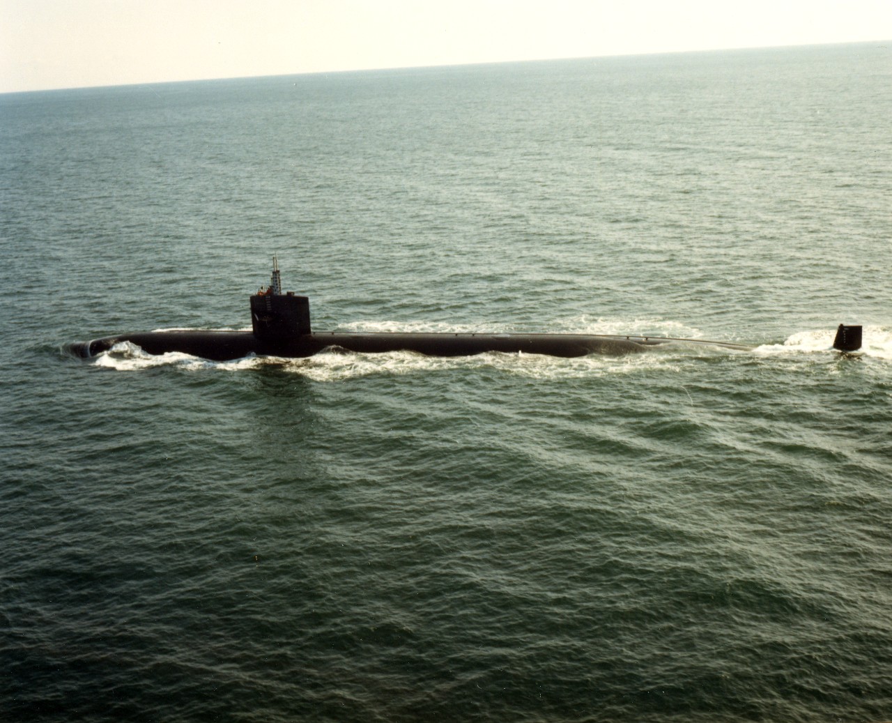 A port view of the nuclear-powered attack submarine USS Houston (SSN-713) underway. January 10, 1983.