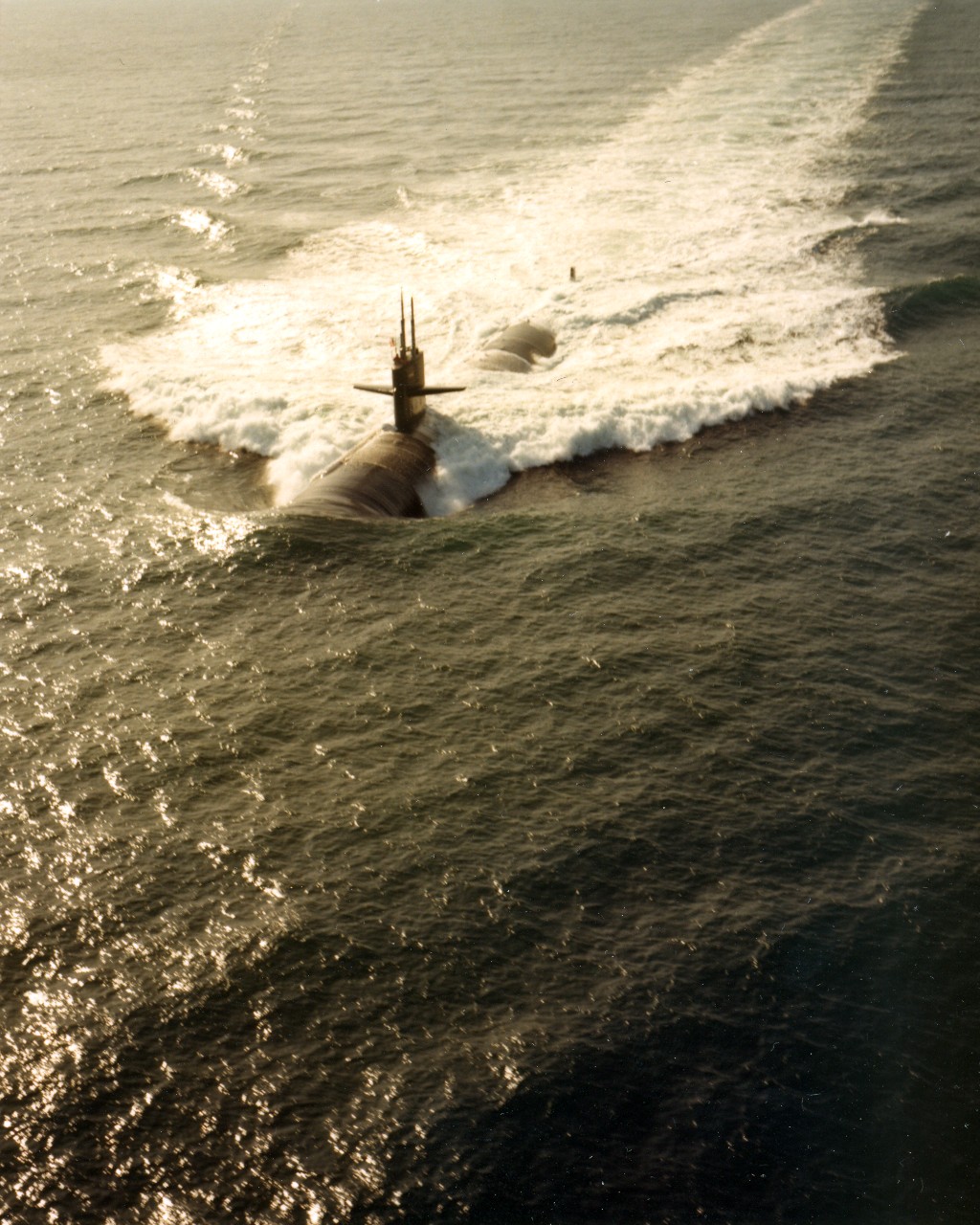 Port view of the nuclear-powered attack submarine USS Houston (SSN-713) underway. January 10, 1983. 