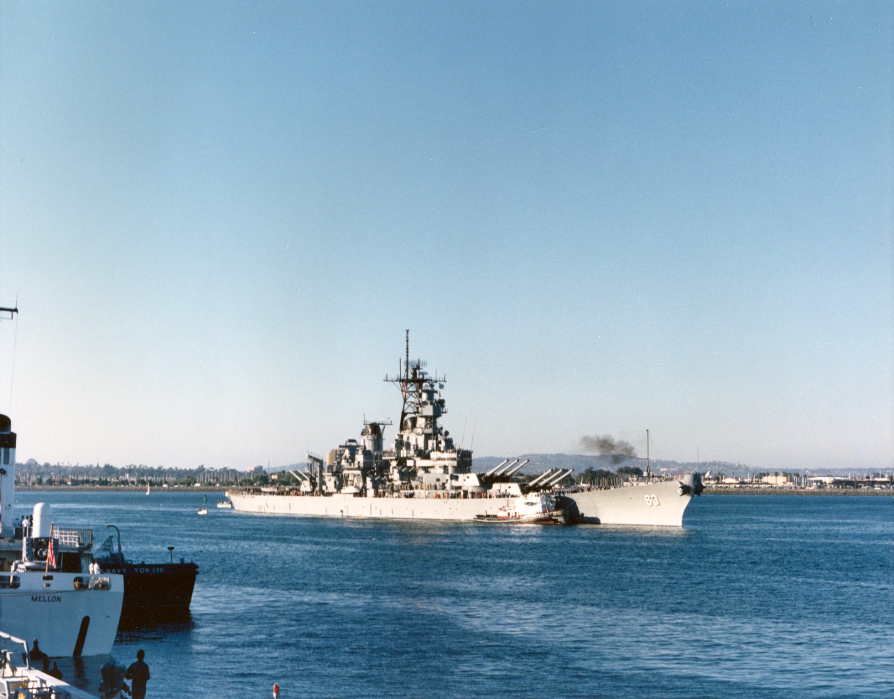 A commercial tug escorts the battleship USS Missouri (BB-63) as the ship prepares to dock at Naval Air Station, North Island.